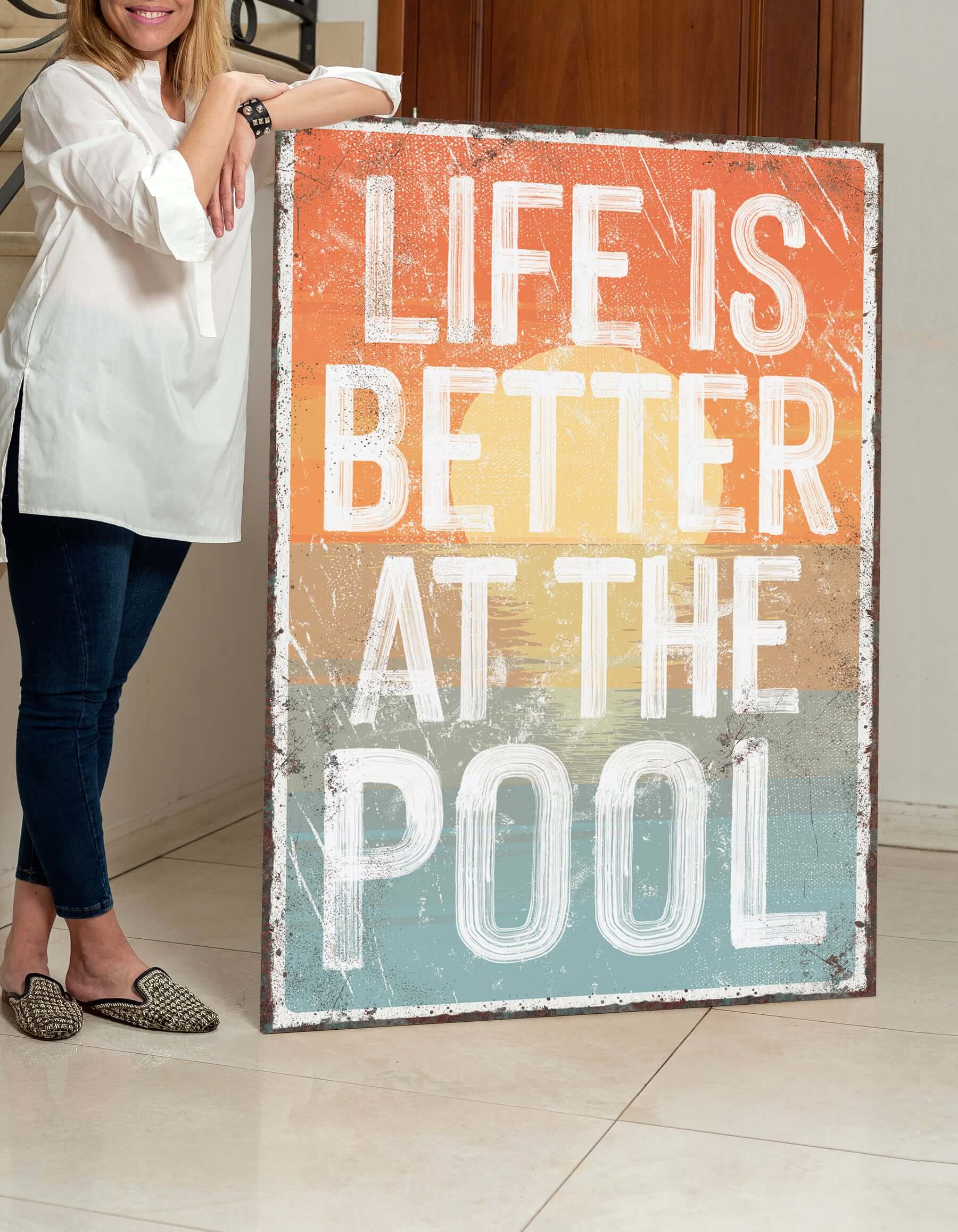 a woman standing next to a sign that says life is better at the pool