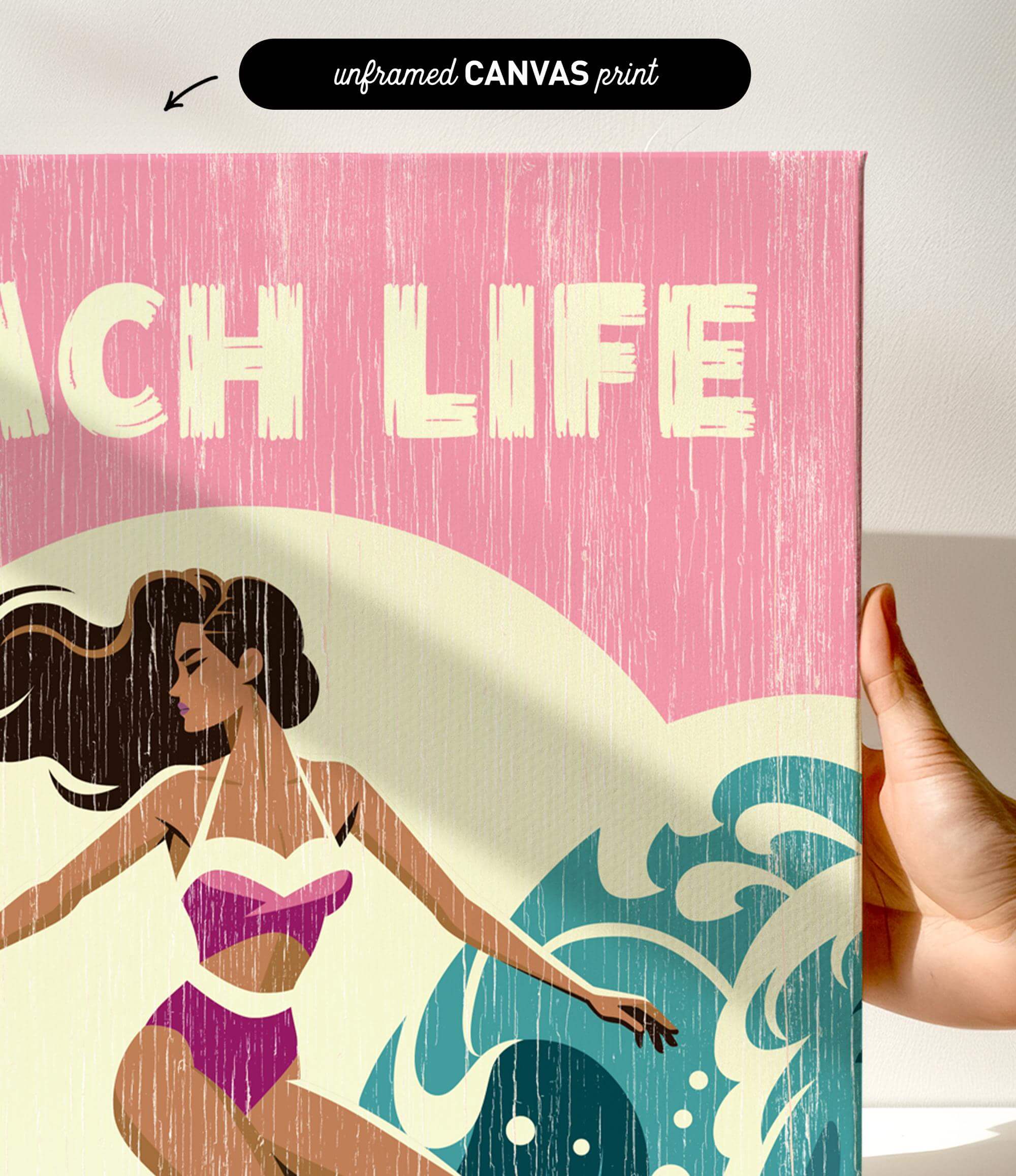 a hand holding a canvas print with a beach scene and a woman in a swimsuit.