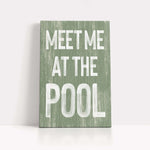 a green sign that says meet me at the pool