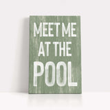 a green sign that says meet me at the pool