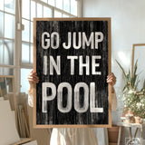 a person holding a sign that says go jump in the pool