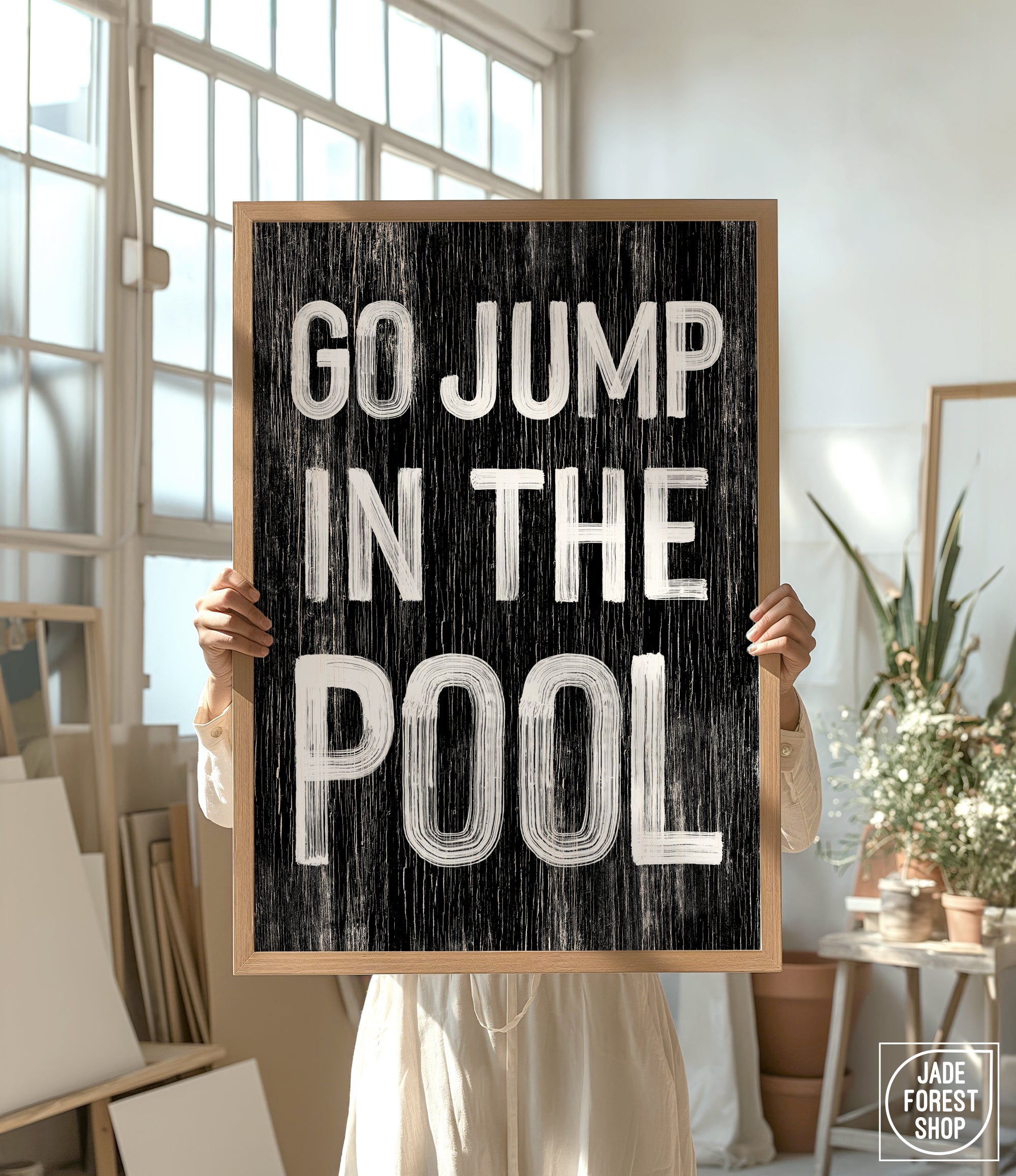 a person holding a sign that says go jump in the pool