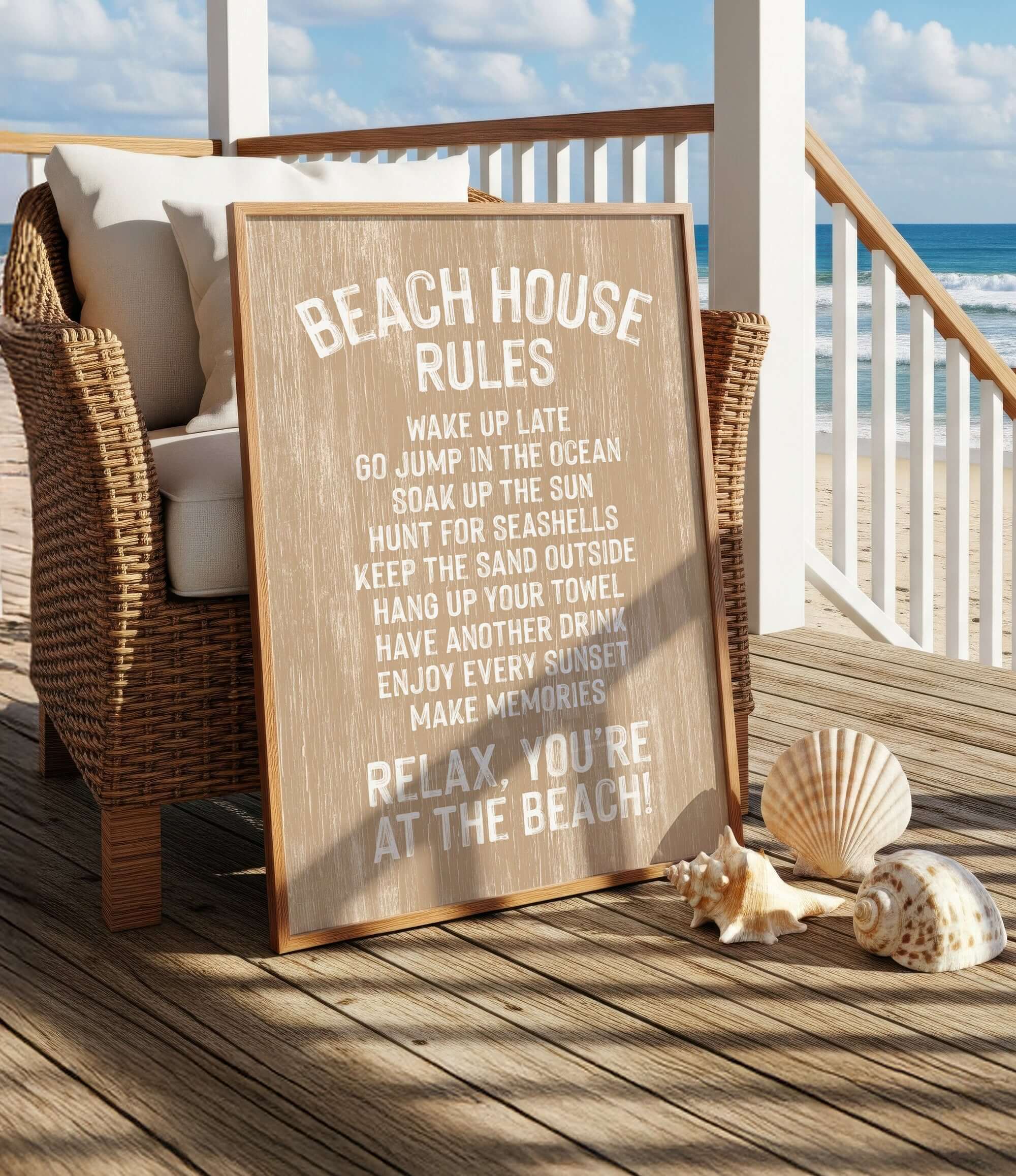 a wooden sign with beach rules, placed on a wooden deck with wicker furniture and seashells nearby, overlooking the ocean.