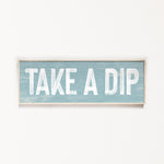 a wooden sign that says take a dip