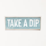 a wooden sign that says take a dip