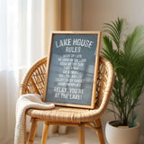 A sign on a wicker chair in a room with a potted plant in the background.