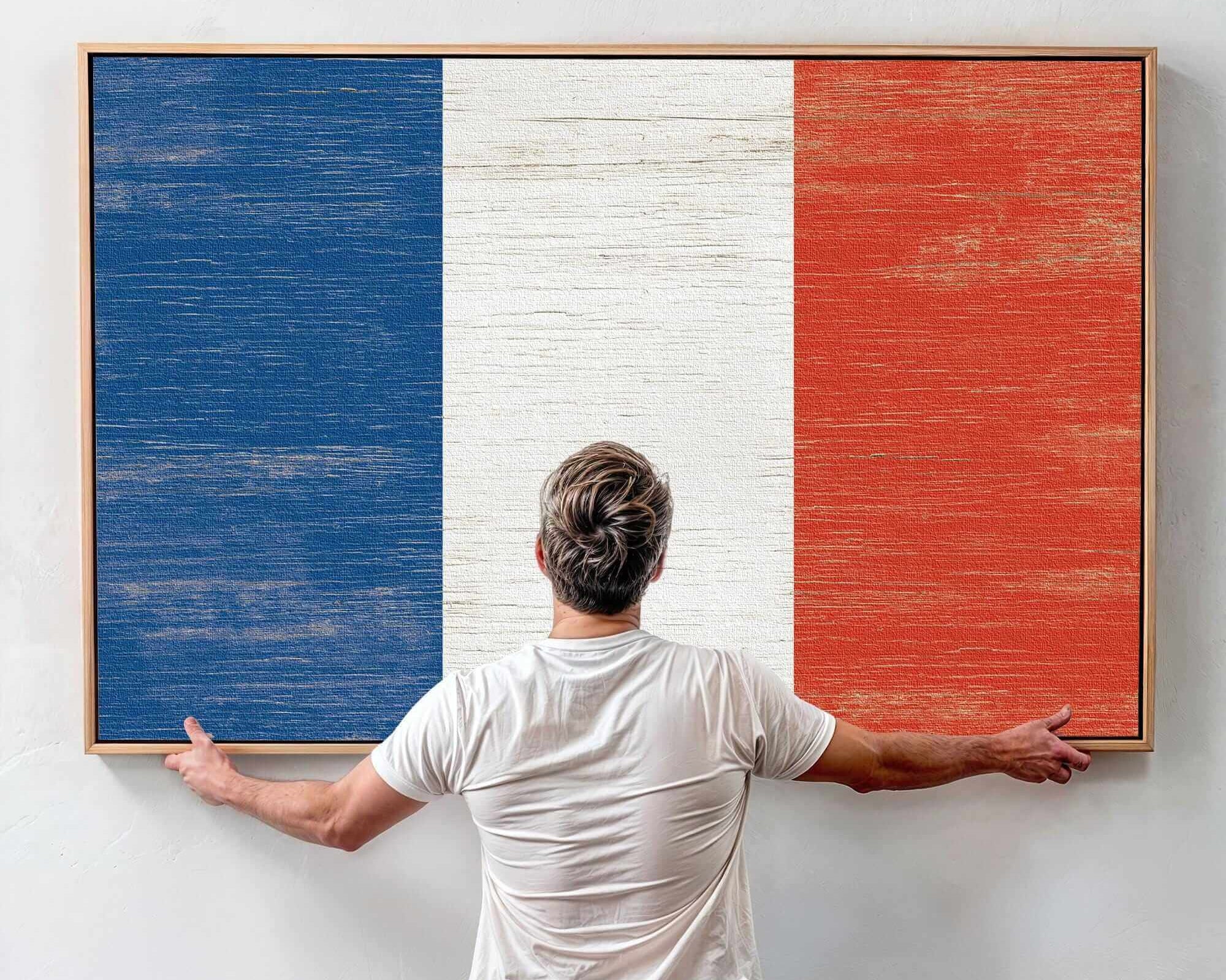 a man standing in front of a painting of the flag of france