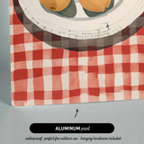 The image is an aluminum print depicting a plate with fruit on a red and white checkered tablecloth.
