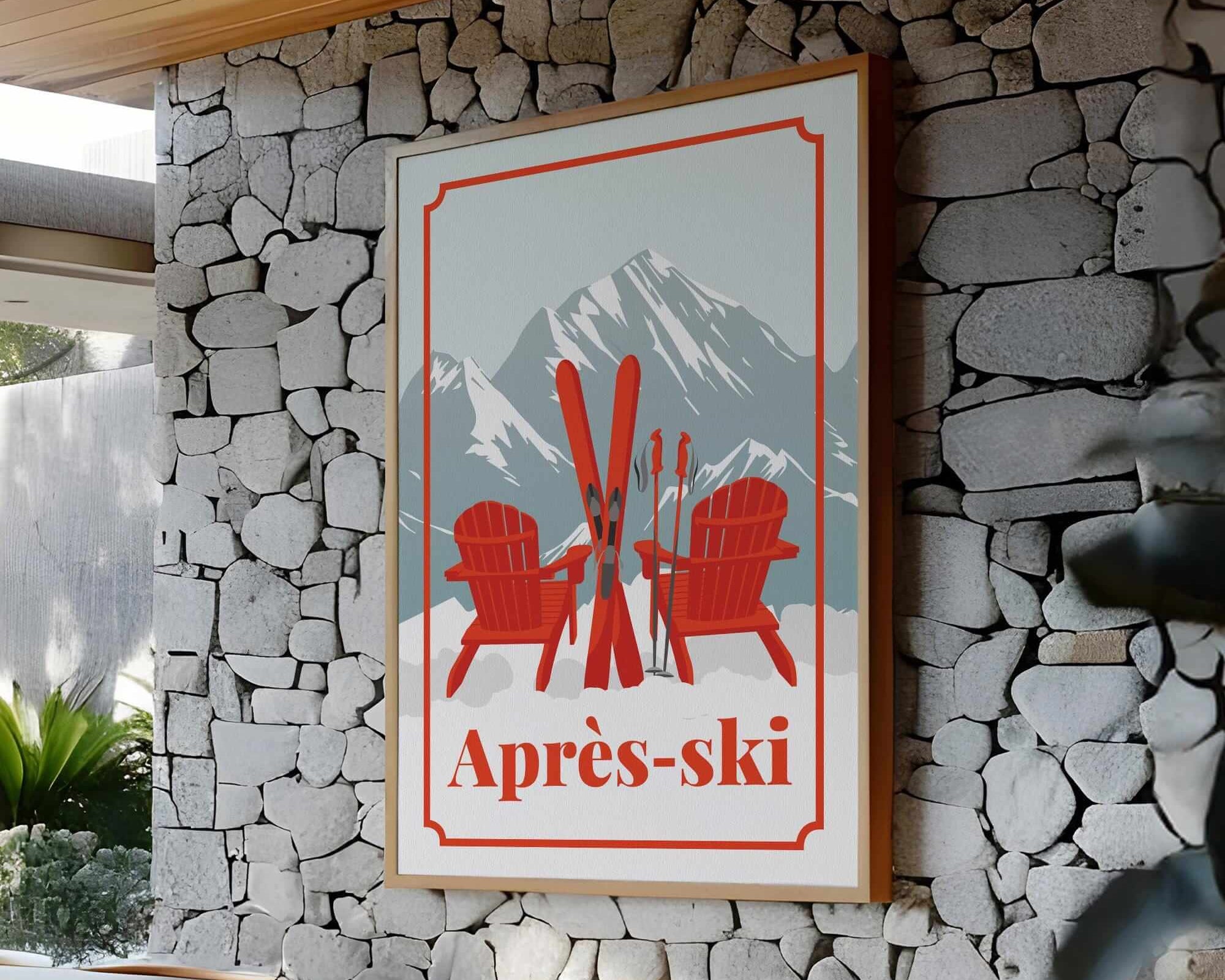 a framed poster with a mountain landscape and two red Adirondack chairs, mounted on a stone wall.