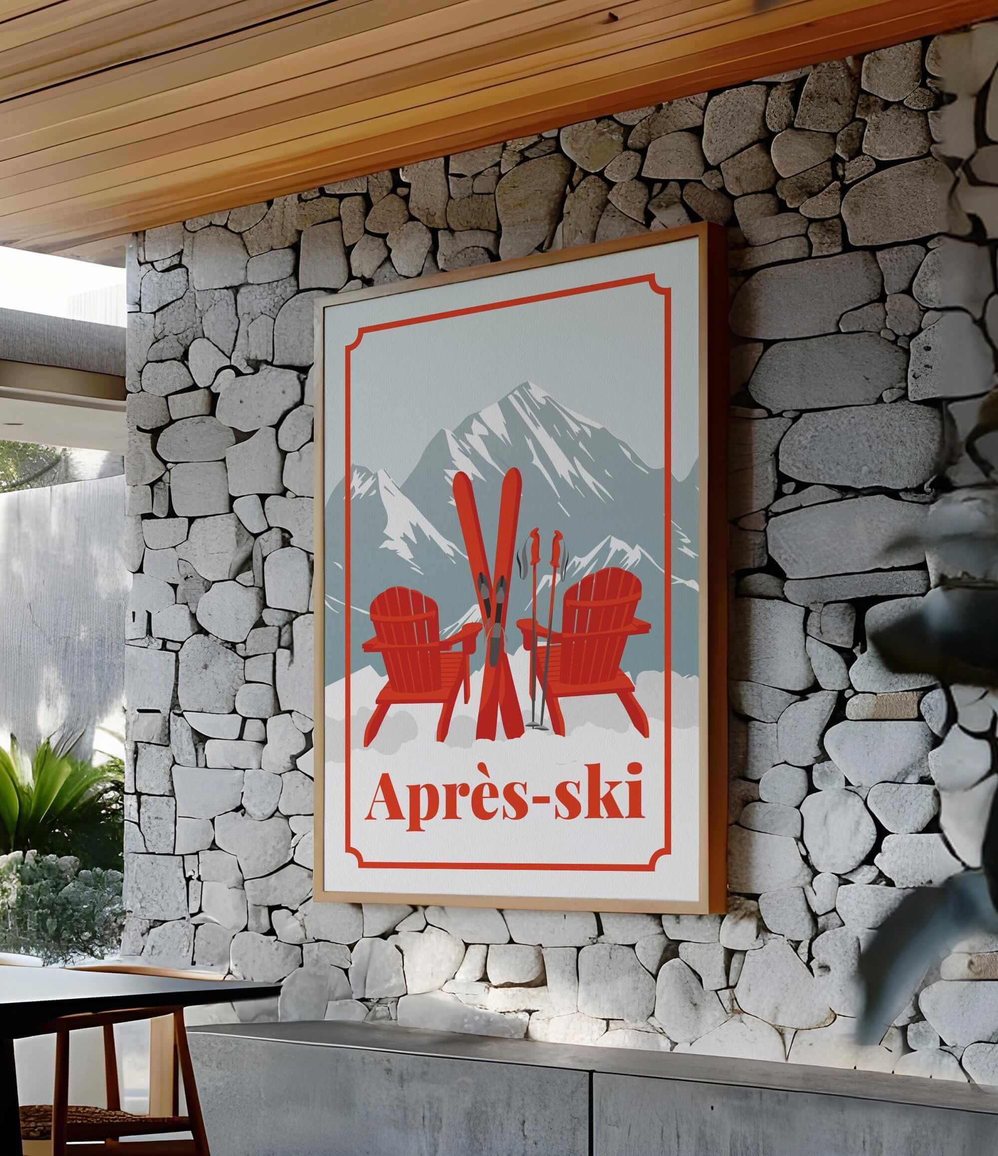 a framed poster with a mountain landscape and two red Adirondack chairs, mounted on a stone wall.