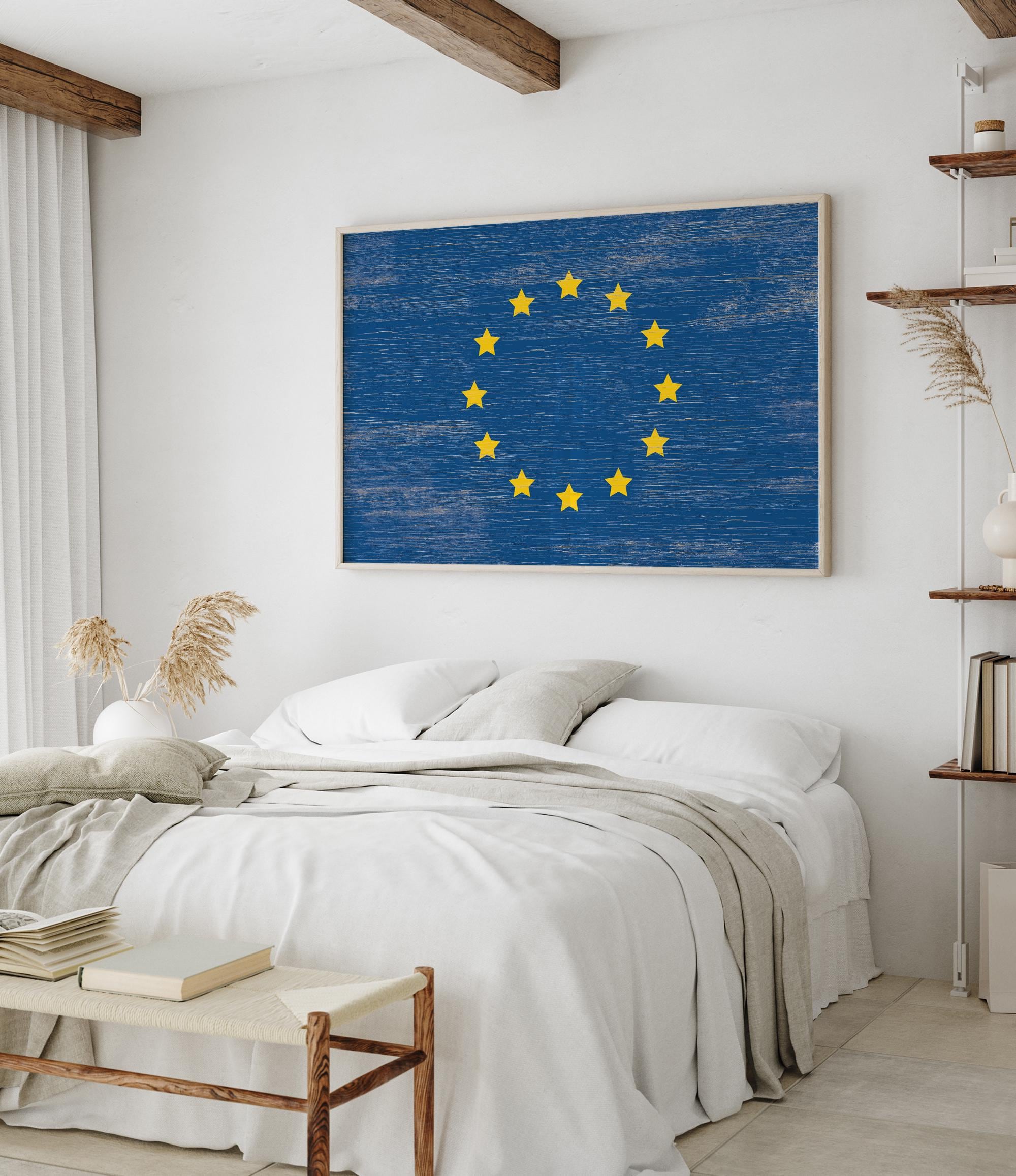 a bedroom with a bed and a painting on the wall