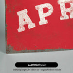 The image is an aluminum print with a red background and the word "APR" in white text.