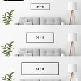 a series of three framed artworks or photographs displayed on a wall, each with a different size and frame. The artworks are arranged in a row, with the largest one being 24 x 8 inches, followed by a smaller one of 36 x 12 inches, and the smallest one being 48 x 16 inches. The artworks are set against a white wall, and there is a plant in the background.