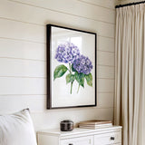 a white dresser with a framed picture of purple hydrangeas hanging on the wall above it.