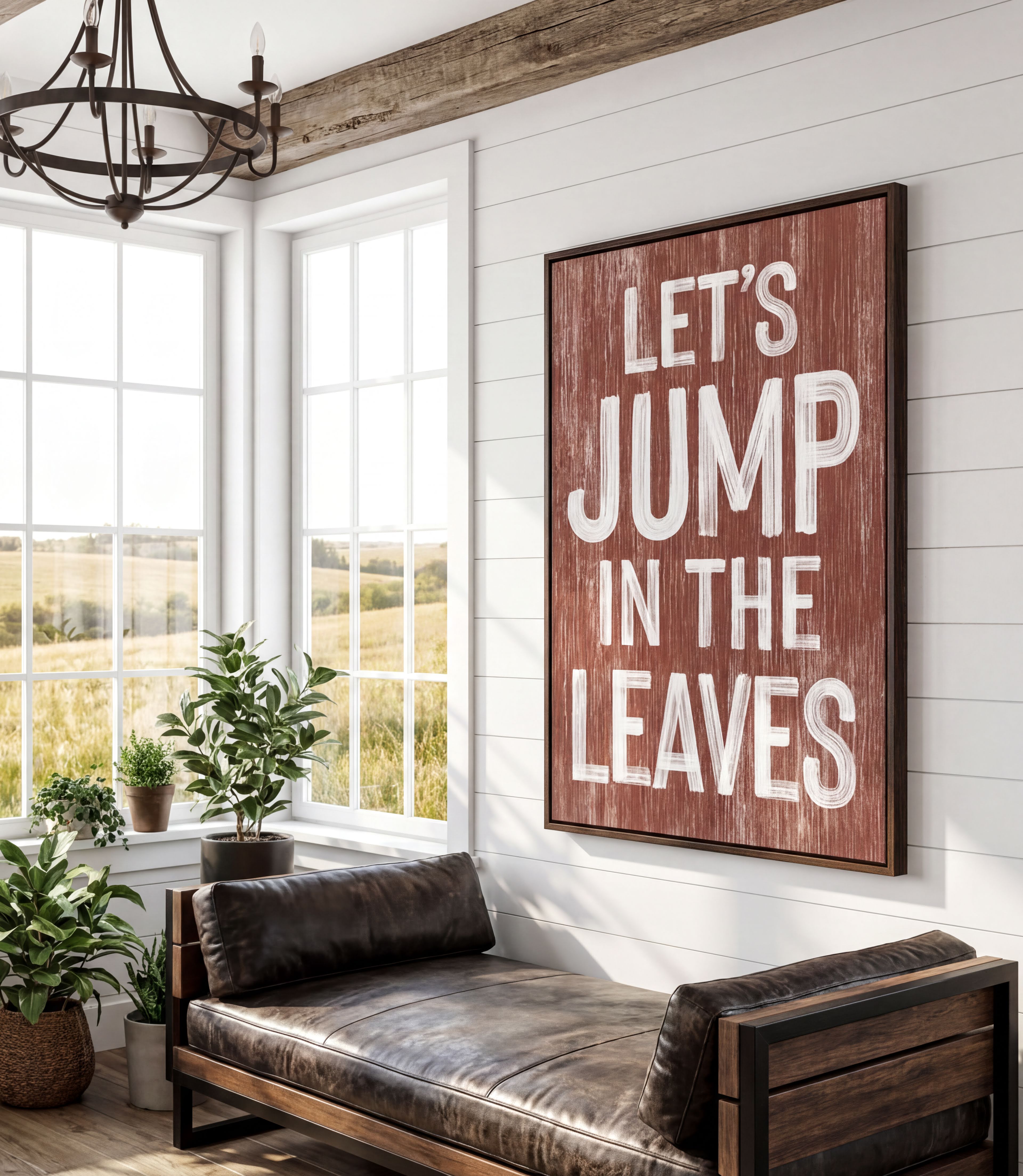 a rustic-style room with a large wooden sign that reads "Let's JUMP IN THE LEAVES" in bold white letters. The sign is mounted on a white wall above a leather couch, which is positioned in front of a window that offers a view of a field. The room also contains several potted plants, adding a touch of greenery to the space.