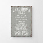 a metal sign that says lake house rules