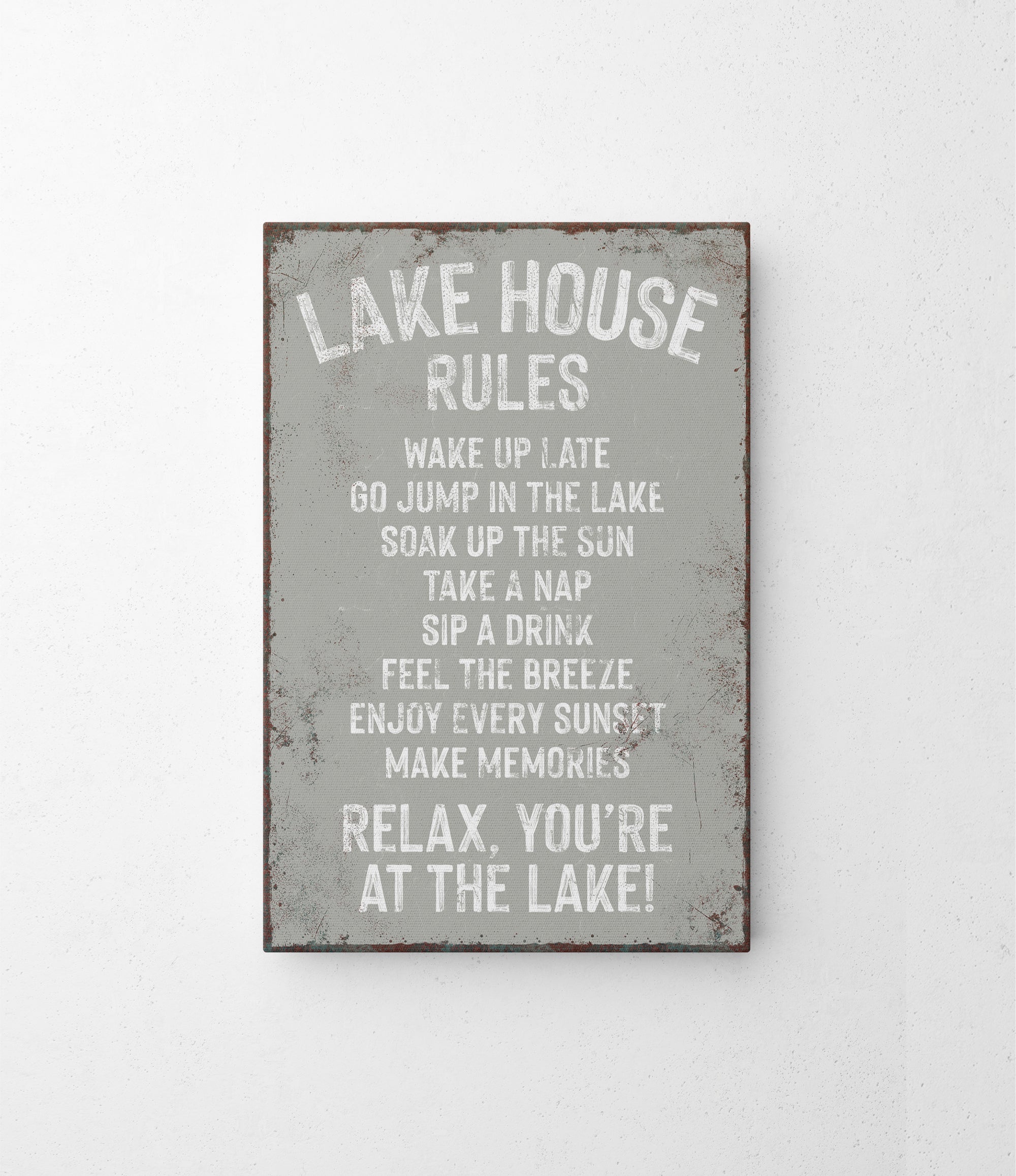 a metal sign that says lake house rules