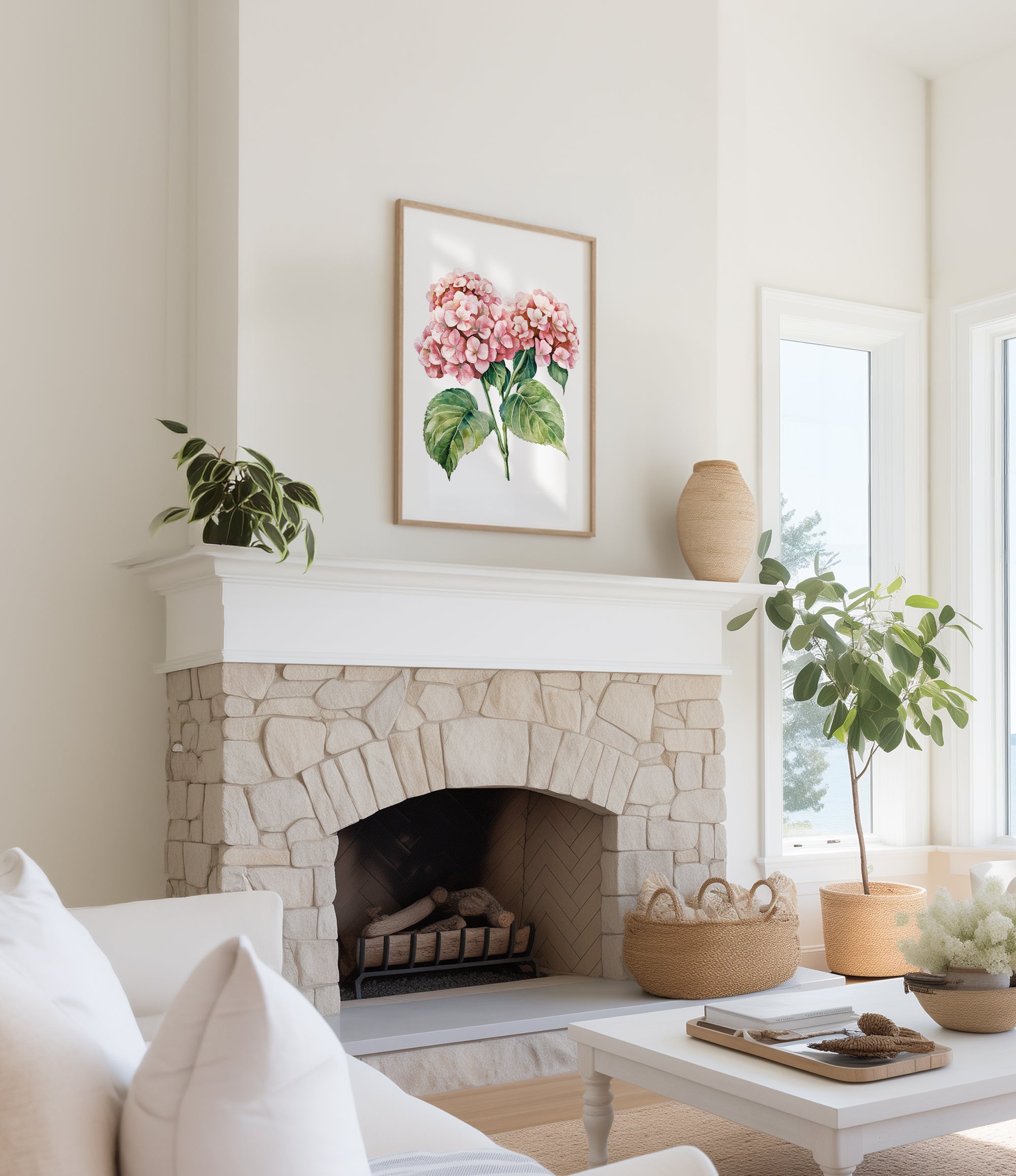 a cozy living room with a stone fireplace, a framed painting of pink flowers hanging above it, and a white sofa. The room is decorated with potted plants and a woven basket, creating a warm and inviting atmosphere.