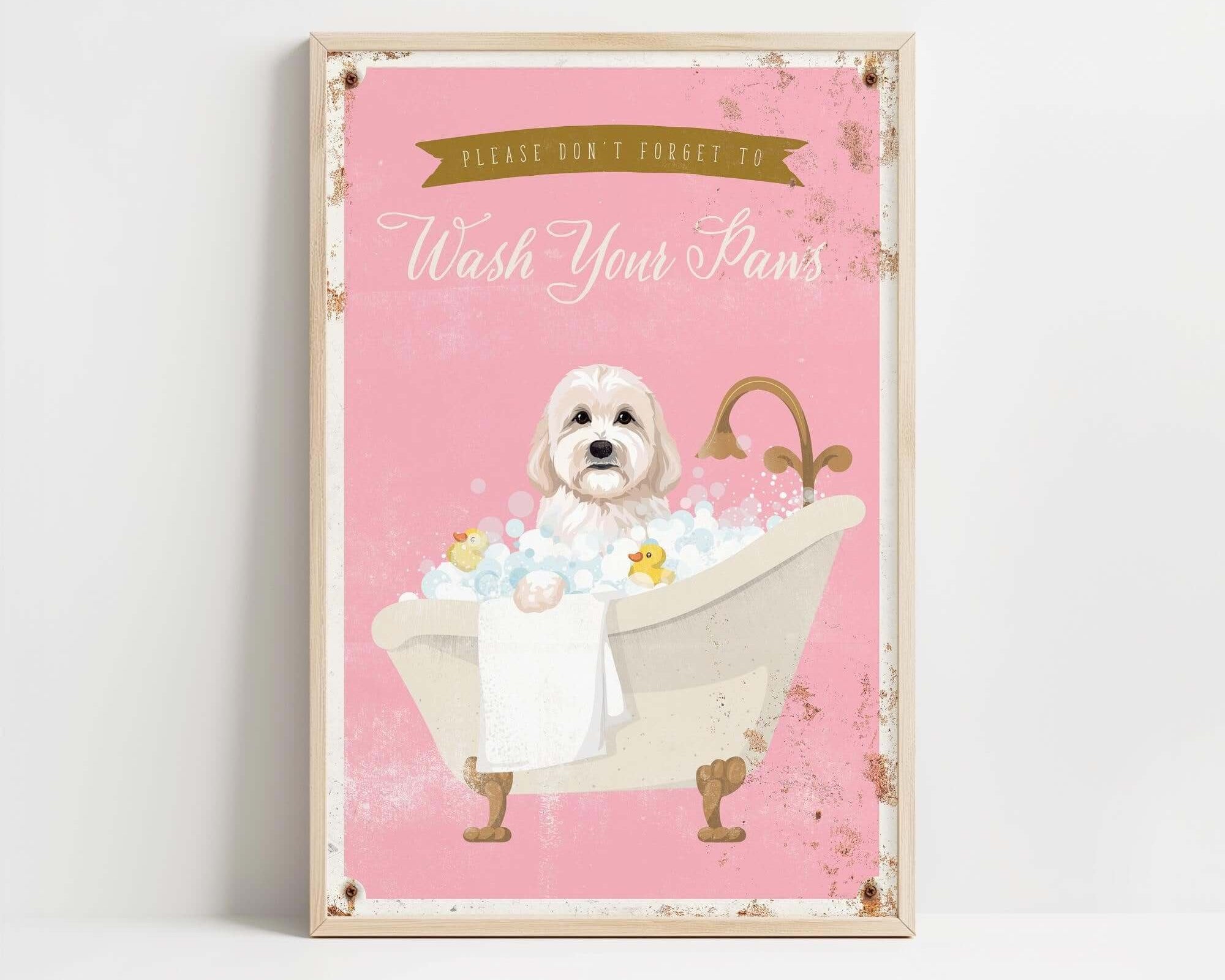 A framed poster with a cute white dog sitting in a bathtub filled with bubbles, accompanied by the text "Please don't forget to wash your paws".