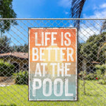 a sign on a fence that says life is better at the pool