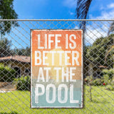 a sign on a fence that says life is better at the pool