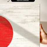 a hand holding a piece of wood with a red circle on it