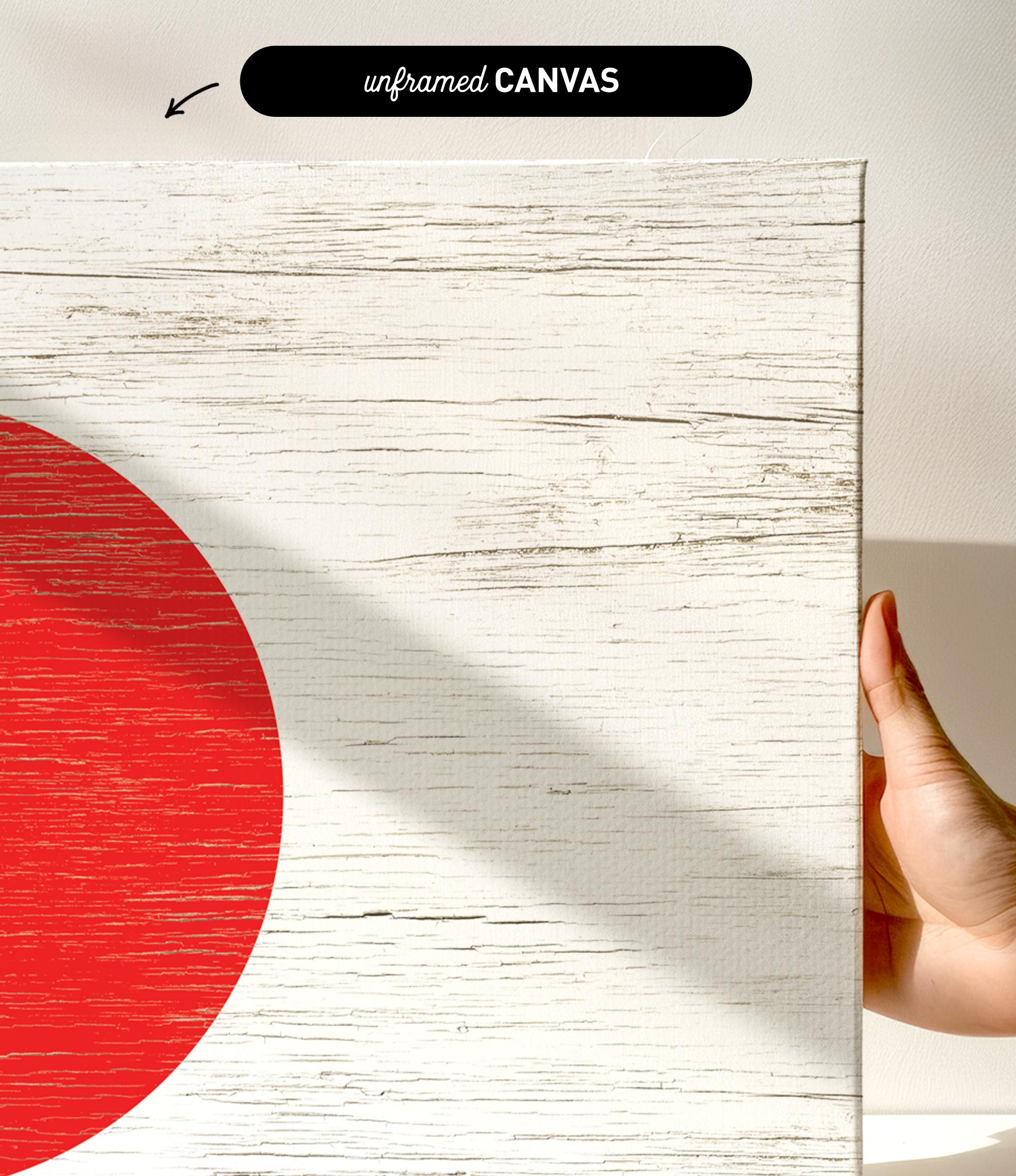 a hand holding a piece of wood with a red circle on it