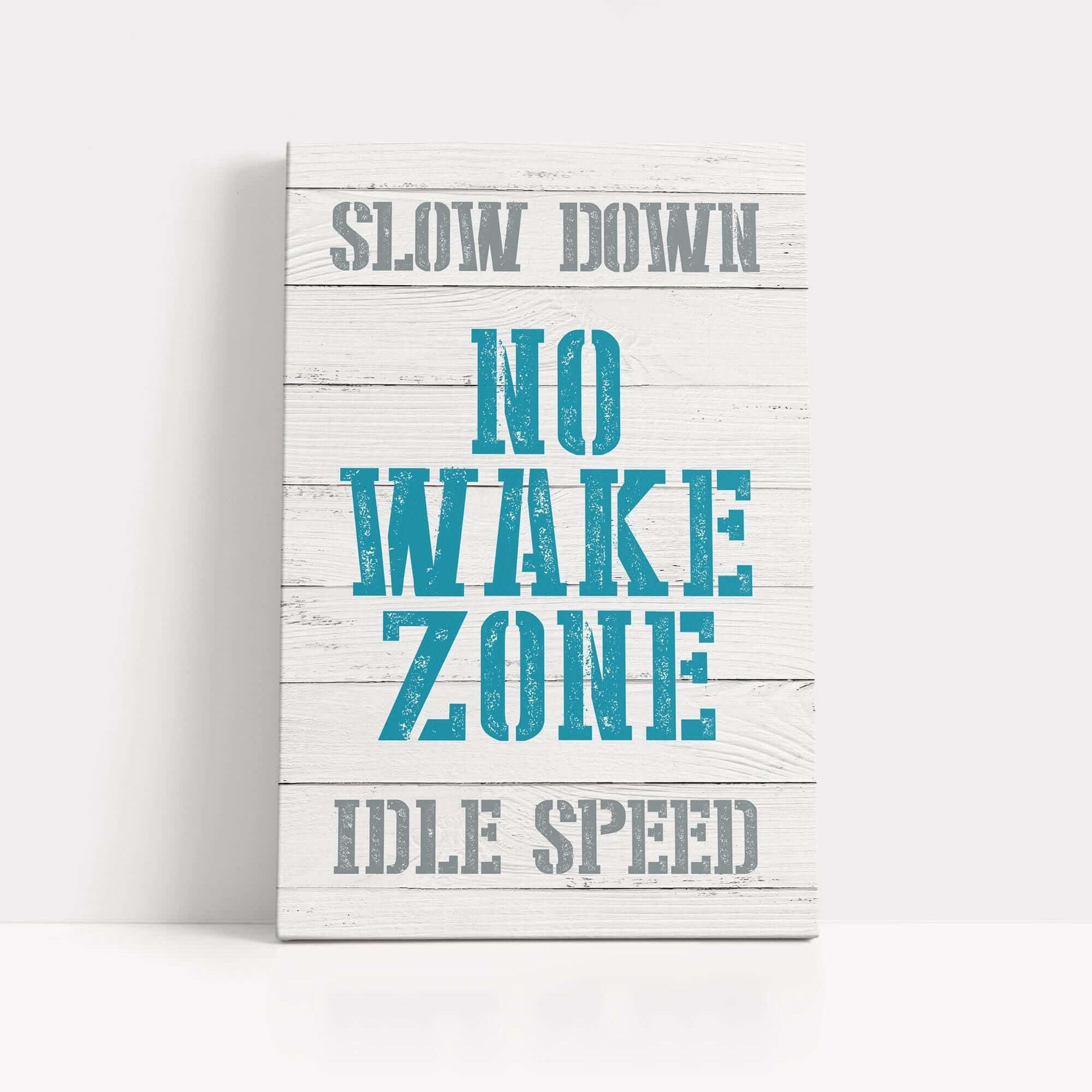 a wooden sign that says slow down no wake zone