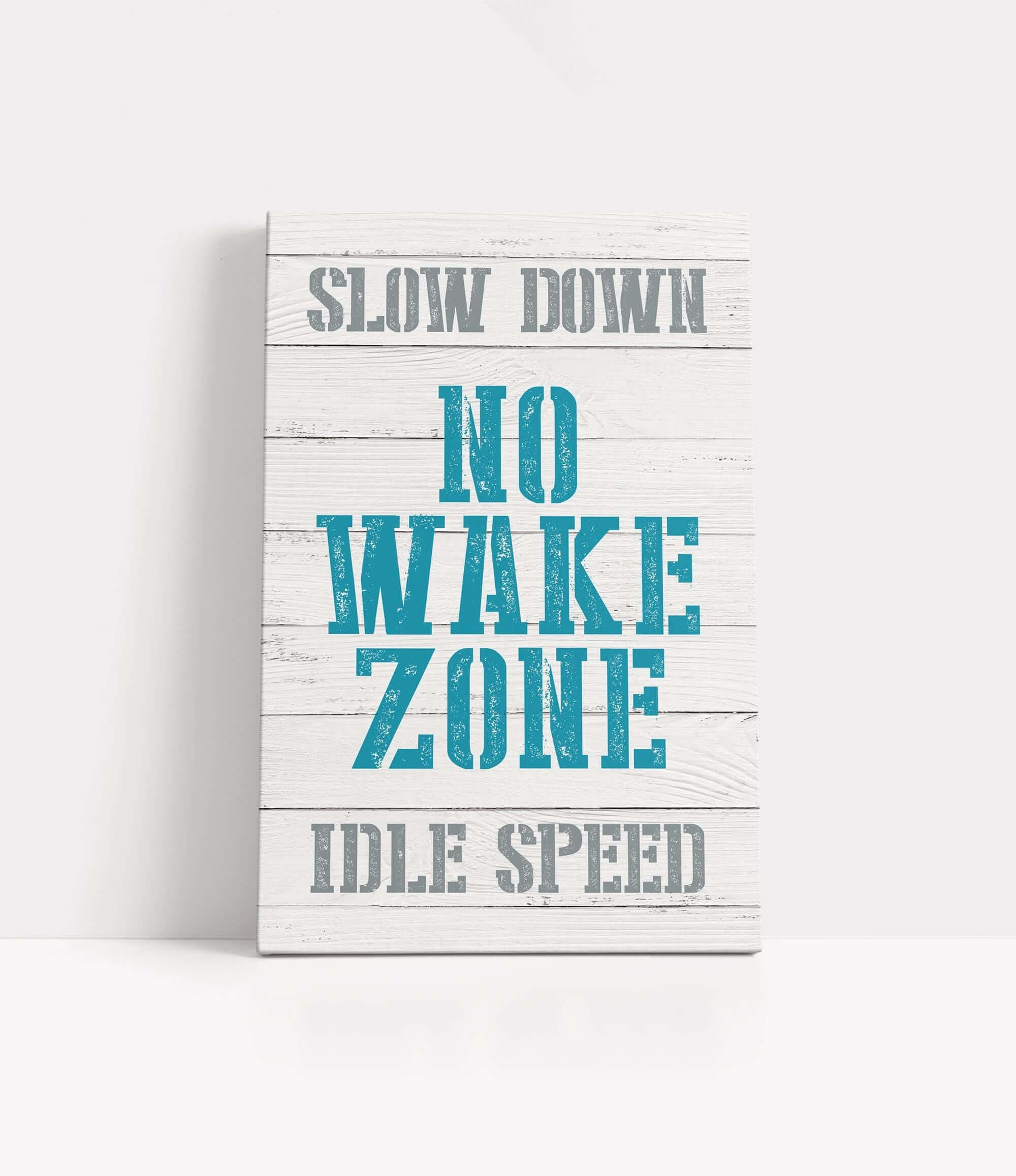 a wooden sign that says slow down no wake zone