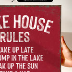 a red sign with white text that reads "Make rules, break rules, take a nap".