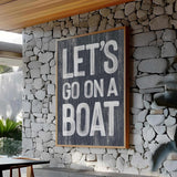a sign that says let&#39;s go on a boat on a stone wall