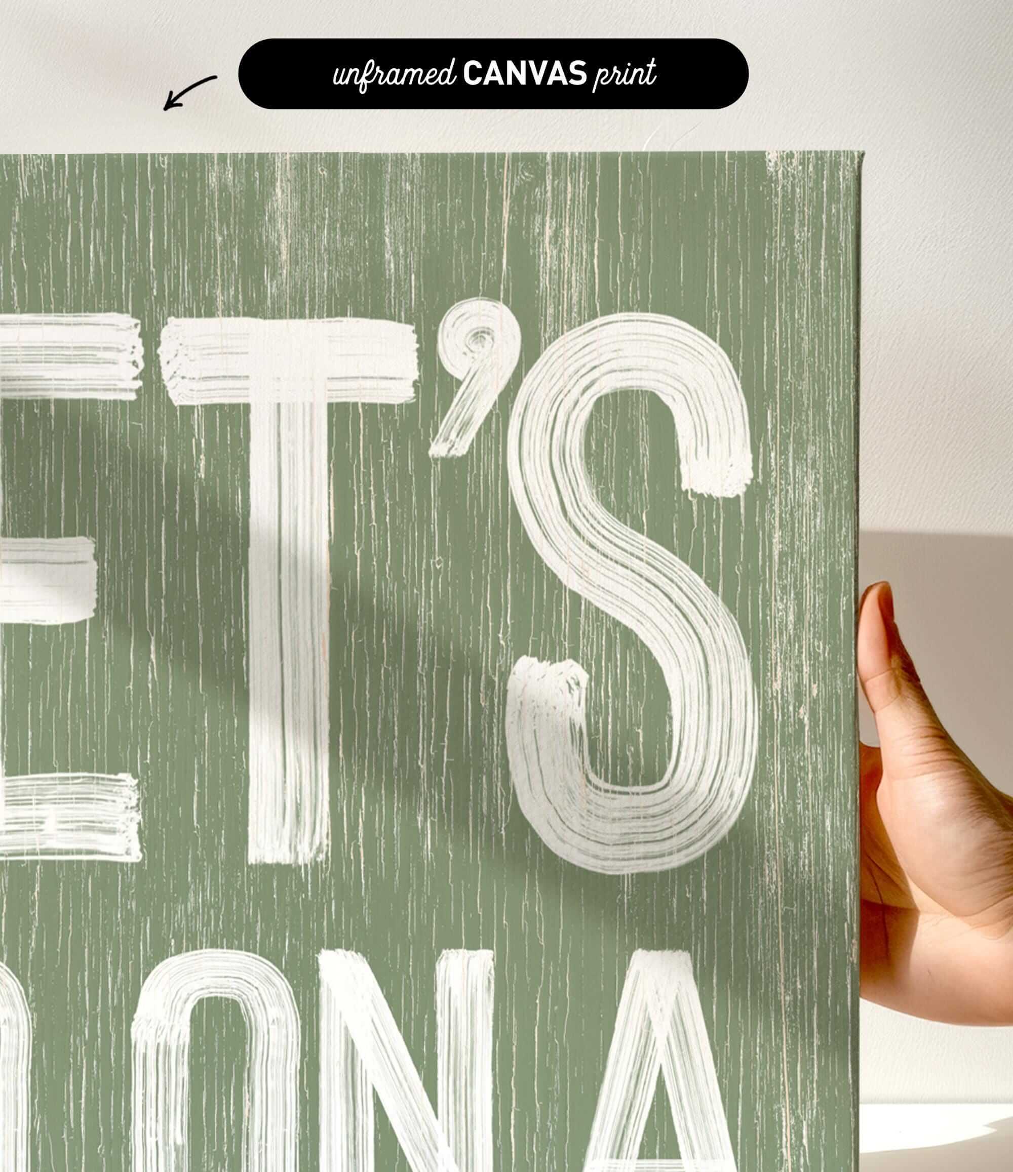 a person holding up a green sign with white letters