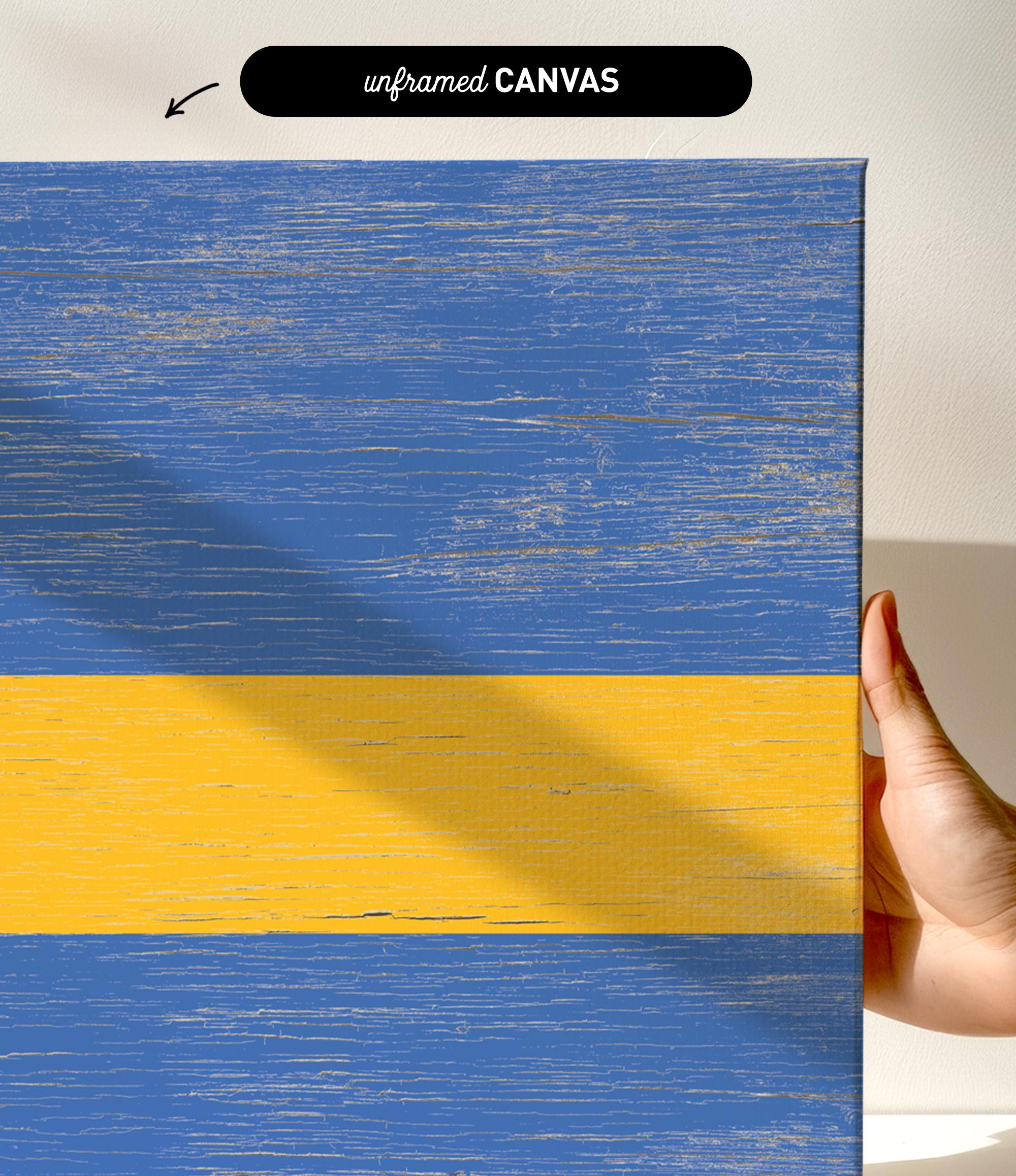 a hand holding a piece of wood with a yellow and blue stripe