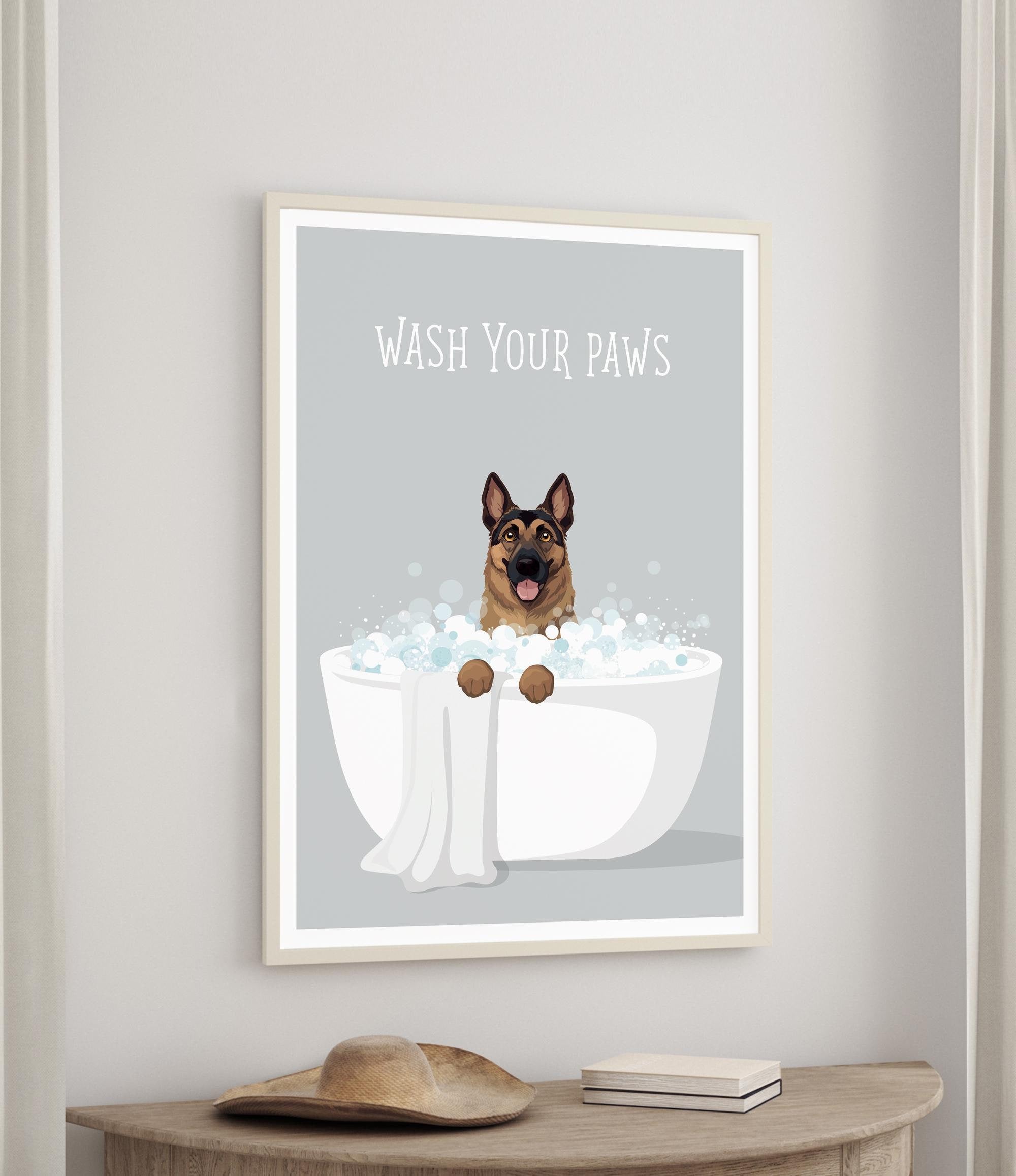 A framed poster with a cartoon image of a dog sitting in a bathtub filled with bubbles, accompanied by the text "WASH YOUR PAWS".