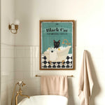 a bathroom with a white bath tub and a black cat poster on the wall
