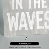 a wooden sign that says in the waves