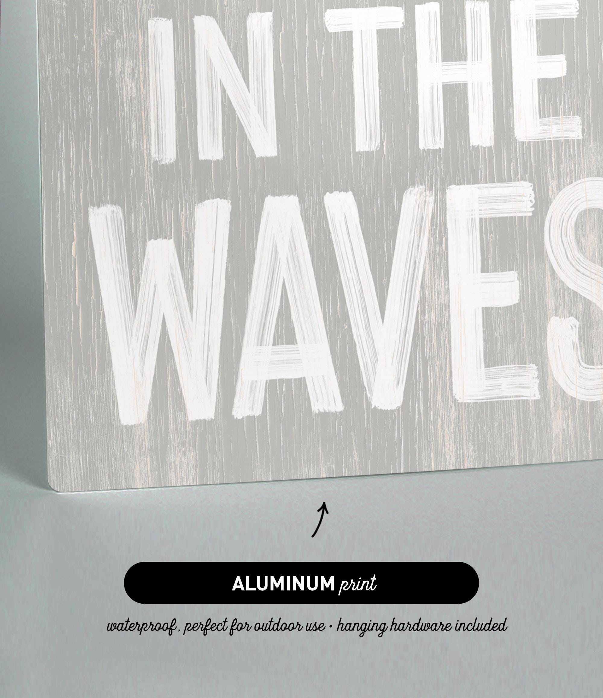 a wooden sign that says in the waves