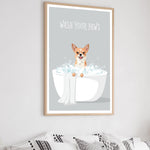 a framed poster with a cartoon illustration of a dog sitting in a bathtub filled with bubbles, with the text "WASH YOUR PAWS" written above it.