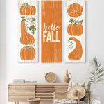 a living room with two paintings of pumpkins on the wall