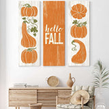 a living room with two paintings of pumpkins on the wall
