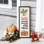 a sign that says hello fall next to some pumpkins