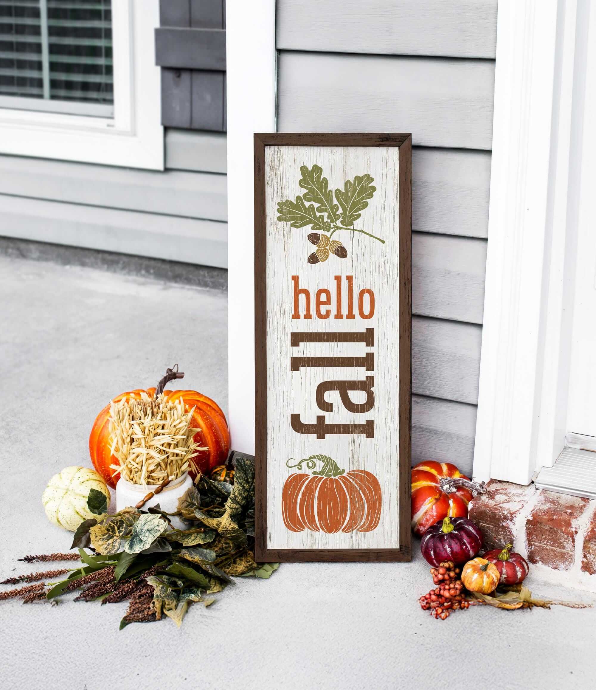 a sign that says hello fall next to some pumpkins