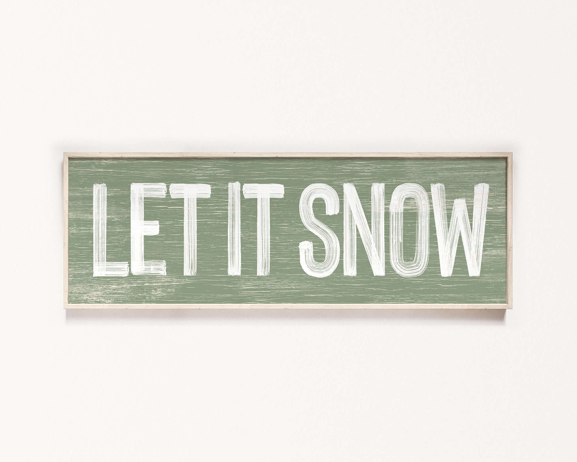 a wooden sign that says let it snow