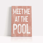 a wooden sign that says meet me at the pool