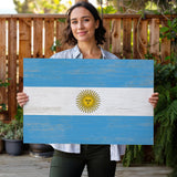 a woman holding a flag of the country of argentina