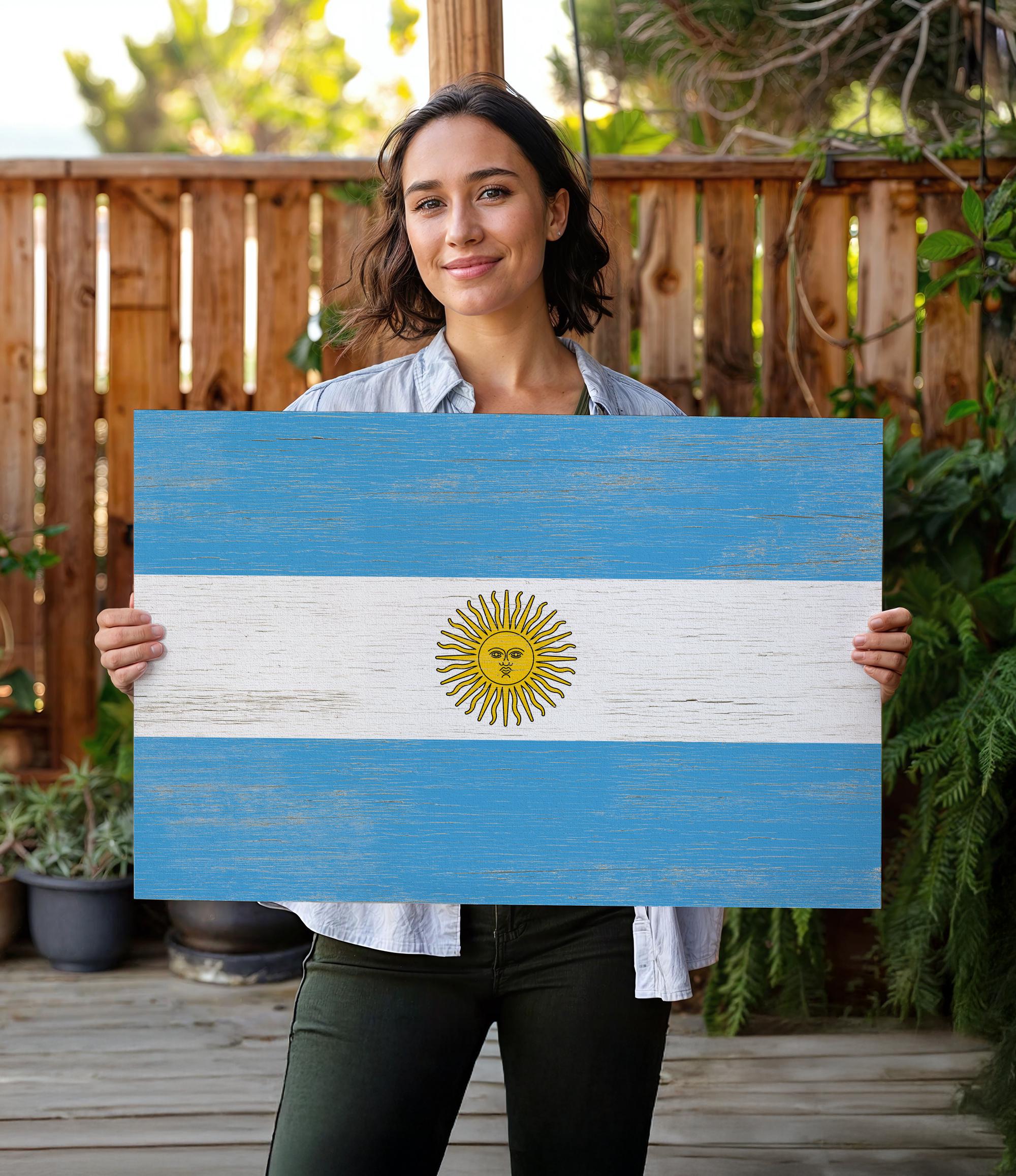 a woman holding a flag of the country of argentina