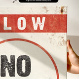 a hand holding a sign that says slow no wave