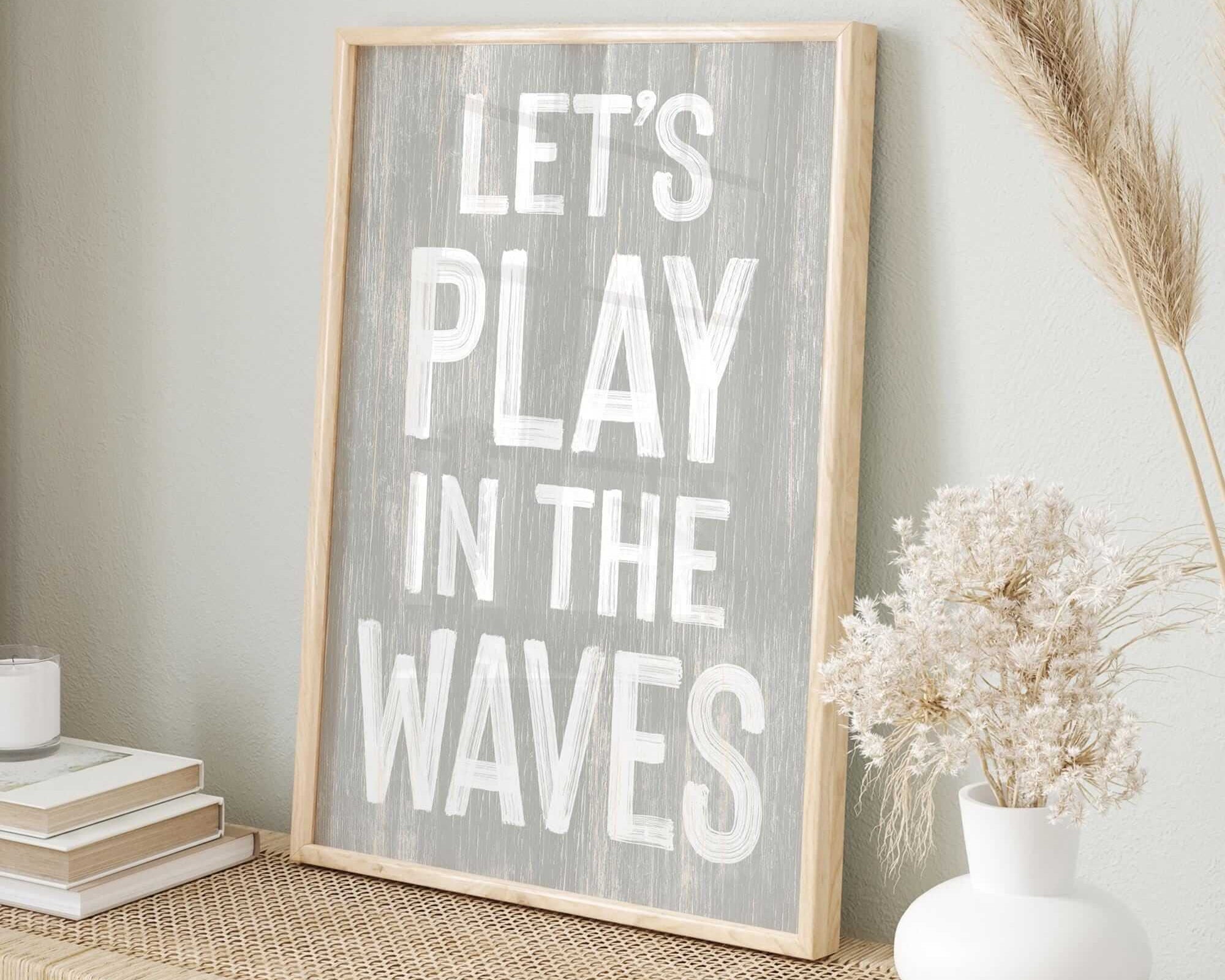 a wooden sign that says let's play in the waves