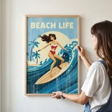 A woman is hanging a framed poster of a woman surfing on a wall.