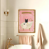 A framed poster with a black cat sitting in a bathtub, accompanied by the text "Please don't forget to wash your paws" in a pink and gold color scheme.